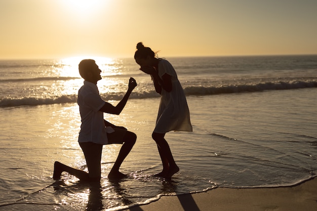 Free Photo | Man proposing woman at seashore on the beach