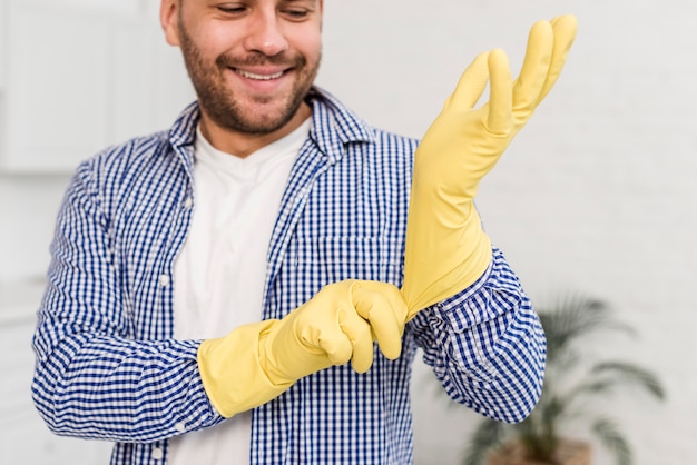 Free Photo | Man putting on cleaning gloves