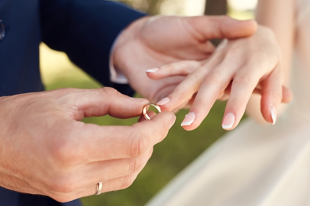 Premium Photo | Man putting a wedding ring on a woman finger