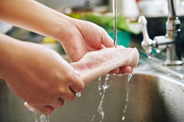 premium-photo-man-rinsing-meat