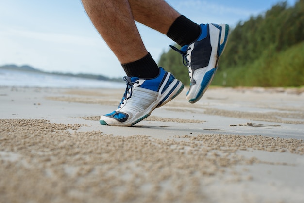 Premium Photo | Man run on the beach, closeup on shoes