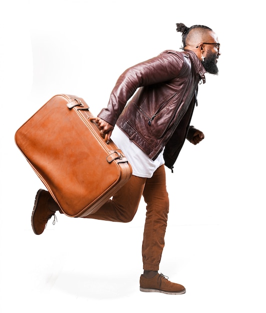 Free Photo | Man running with a brown suitcase