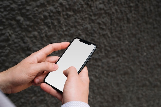 Free Photo | Man's hand holding cell phone with blank screen