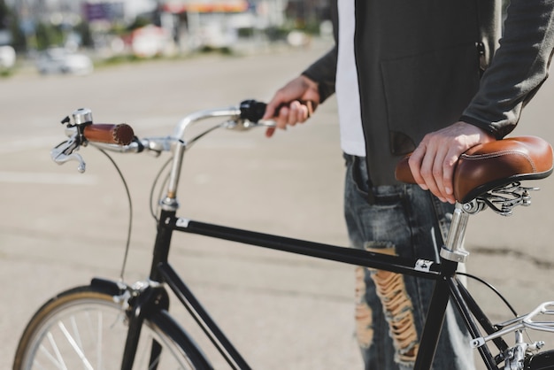 Free Photo | Man's standing with bicycle on road