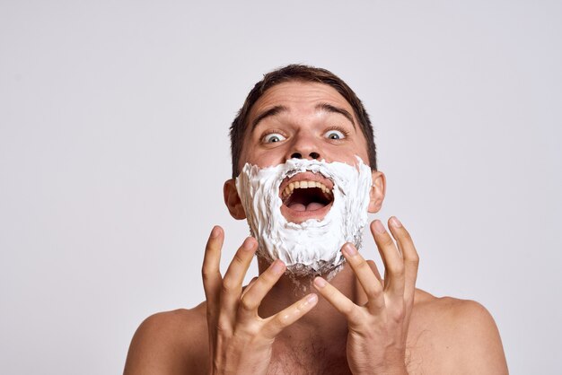 Premium Photo Man Shaving His Beard With Shaving Foam Funny Expression