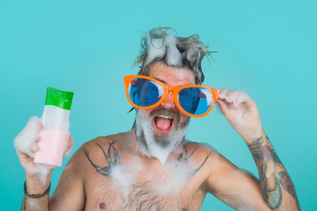 Premium Photo Man In Shower Man Holds Shampoo Bottle Man With Foam On