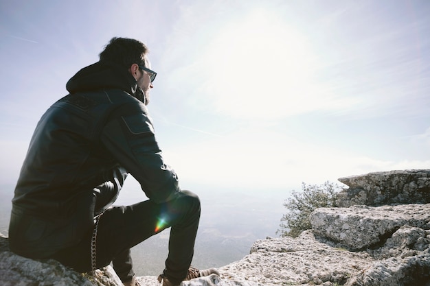 Free Photo | Man sitting on rock