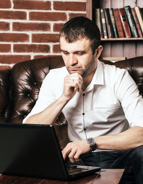 Premium Photo Man Sitting At Table With Laptop Videoconference In