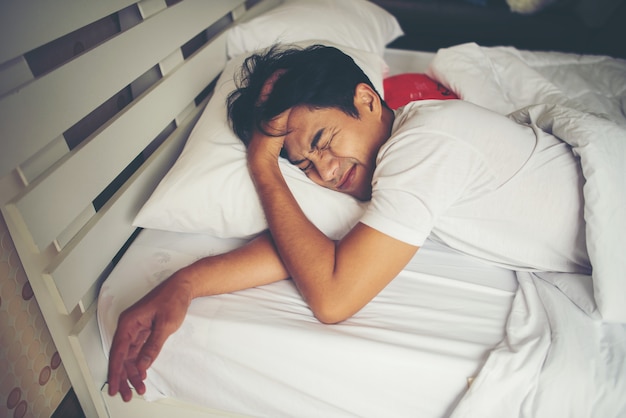 Man sleeping on bed in the morning Free Photo