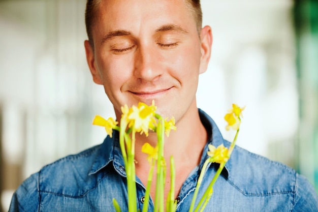 Premium Photo | Man smelling a flower