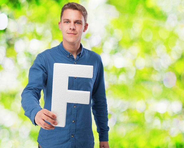 Free Photo | Man smiling holding the letter 