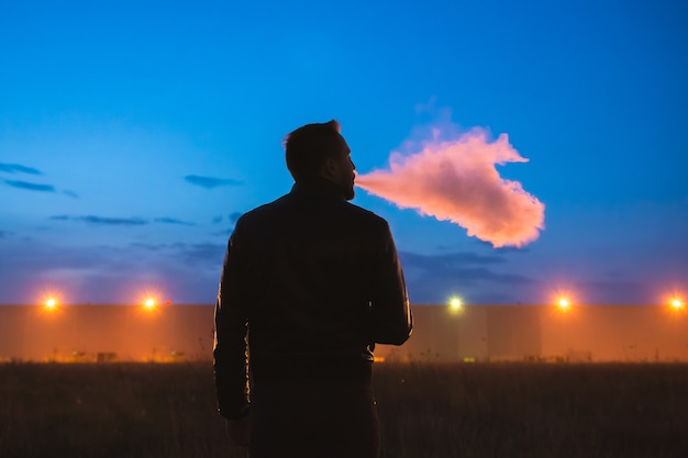 Premium Photo | The man smoke cigarette near the building. evening ...