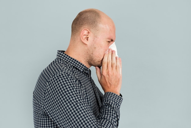 Man sneezing blowing nose sickness Free Photo
