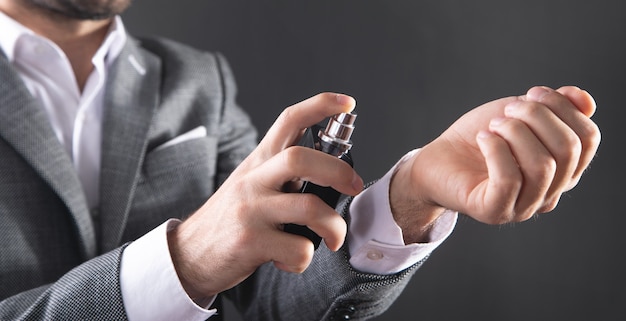 Premium Photo | Man spraying perfume in hand.