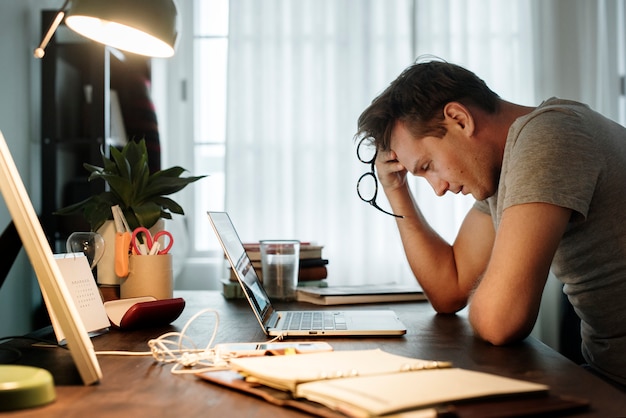 Man stressed while working on laptop Premium Photo