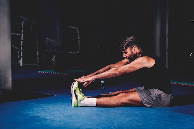 Free Photo | Man stretching in gym