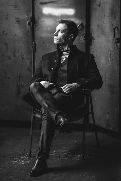 Premium Photo | Man in a suit and coat poses in elegant outfit