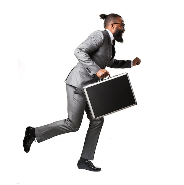 Man in suit running with a briefcase | Free Photo