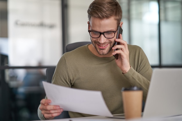 Premium Photo | Man talking on phone in cozy cabinet