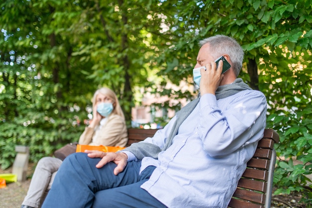 Premium Photo | Man talking on the phone while keeping his distance ...