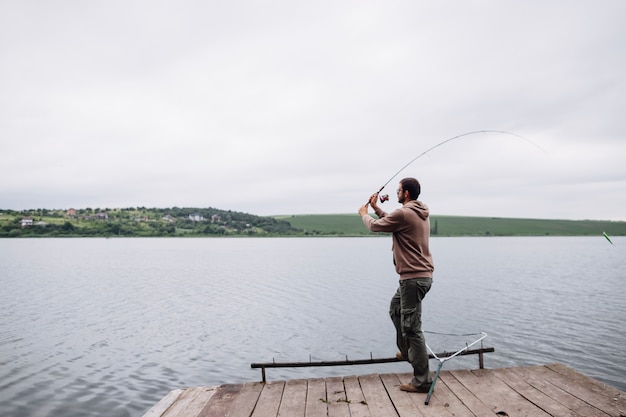 Free Photo | Man throwing fishing line in the lake