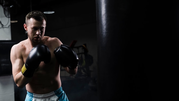 Man training hard for a boxing competition with copy space Photo | Free ...