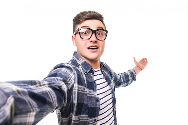 Man in transparent glasses taking a selfie isolated on white wall Free Photo