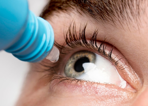 Man using eye drops close-up Free Photo