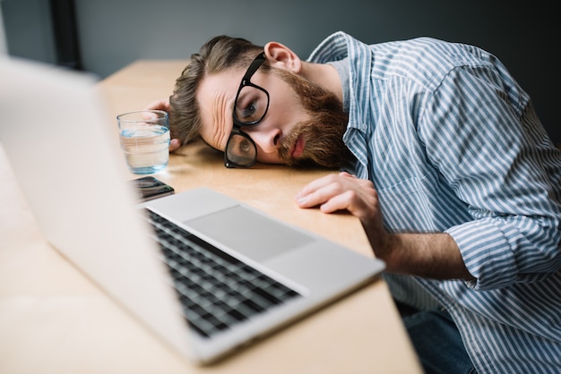 Premium Photo | Man using laptop, feeling tired