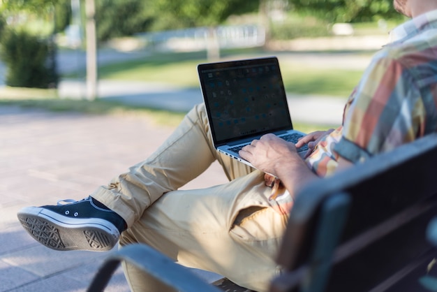 Free Photo | Man using laptop in park