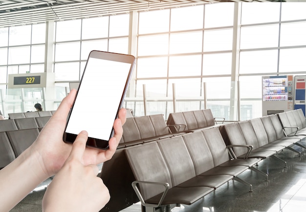 Man using smart phone mobile in the airport terminal Premium Photo