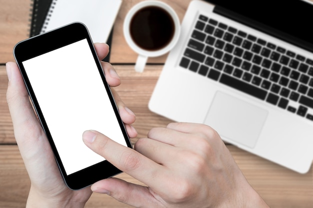 Premium Photo | Man using smartphone over the office desk