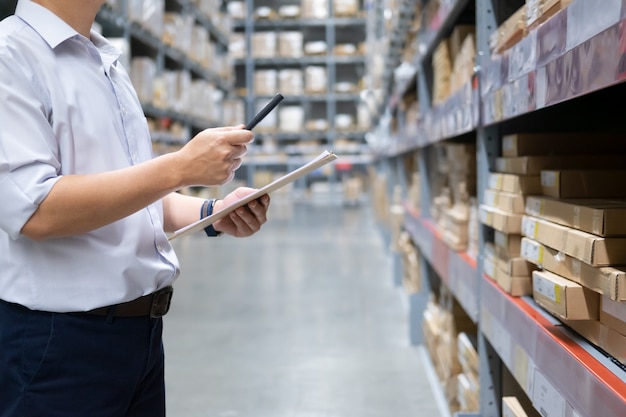 Premium Photo | Man warehouse worker checking goods at warehouse.