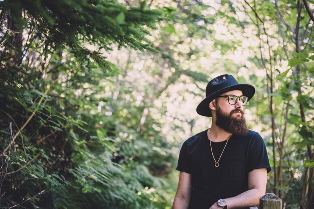 Free Photo | Man wearing black hat in forest