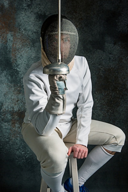 The man wearing fencing suit with sword Photo | Free Download