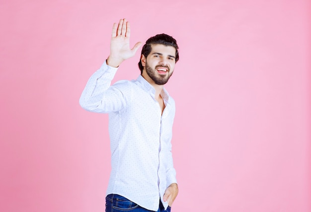 free-photo-man-in-a-white-shirt-stopping-something