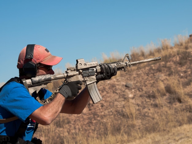 Premium Photo | Man with ar-15 practicing target shooting.