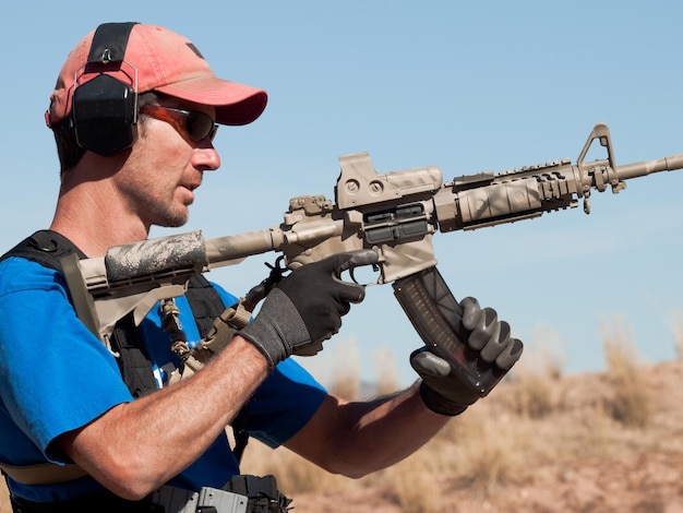 Premium Photo Man With Ar 15 Practicing Target Shooting