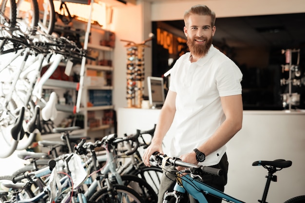 Premium Photo | A man with a beard posing with a bicycle.