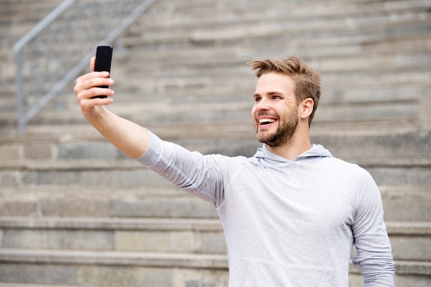 Premium Photo Man With Beard Walks With Smartphone Urban Background