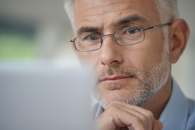 Premium Photo Man With Glasses Working On A Computer