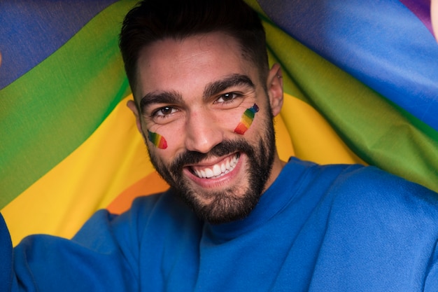 Man With Lgbt Rainbow On Face On Gay Parade Free Photo