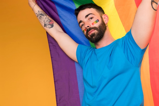 Man With Lgbt Rainbow On Face With Multicolored Flag Free Photo