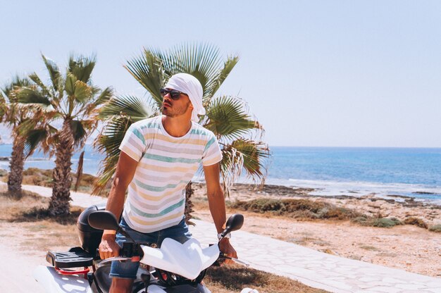 Man with map travalling on atv by the sea Free Photo