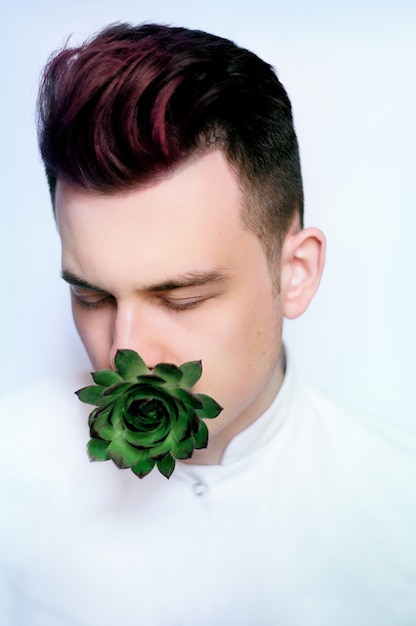 Man With Red Hair Holds Green Flower In His Mouth Photo