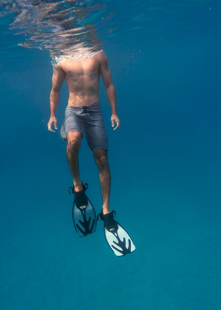 Free Photo Man With Scuba Gear Swimming In The Ocean