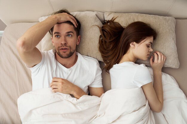 Premium Photo | Man and woman sleep in bed, phone, cheating, love  relationship
image on different types of women in bed
