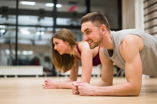 Man and woman stretching at the gym Free Photo