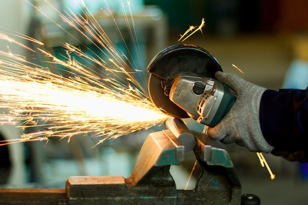 A man working with hand tools. hands and sparks close-up. Photo