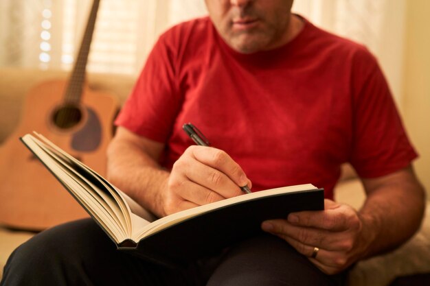 Premium Photo A Man Writing In A Book